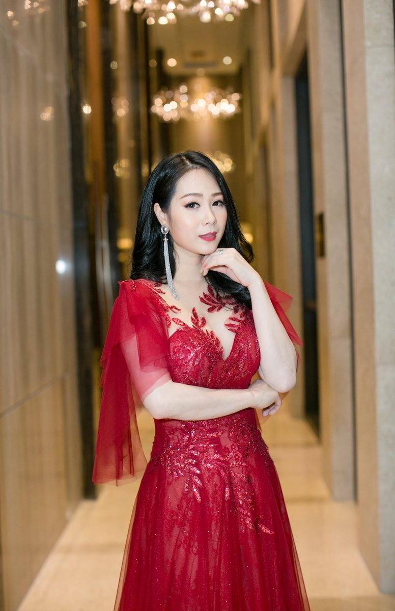Irene Ho in a red lace gown — Vietnamese event MC portrait